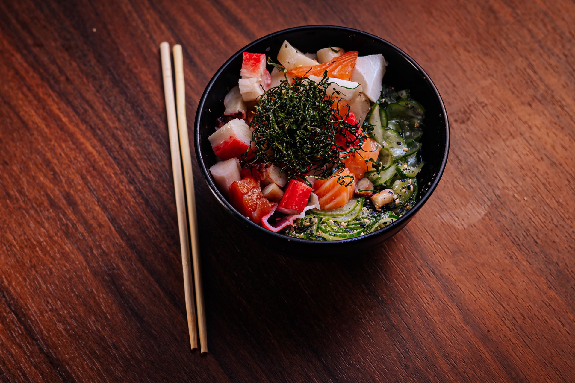 Colorful poke bowl with fresh fish and vegetables