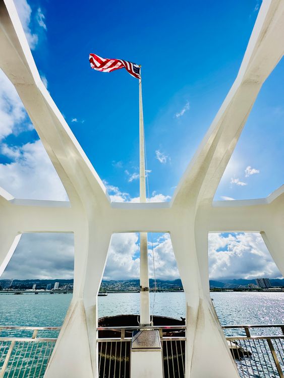 USS Arizona Memorial with American flag and ocean view